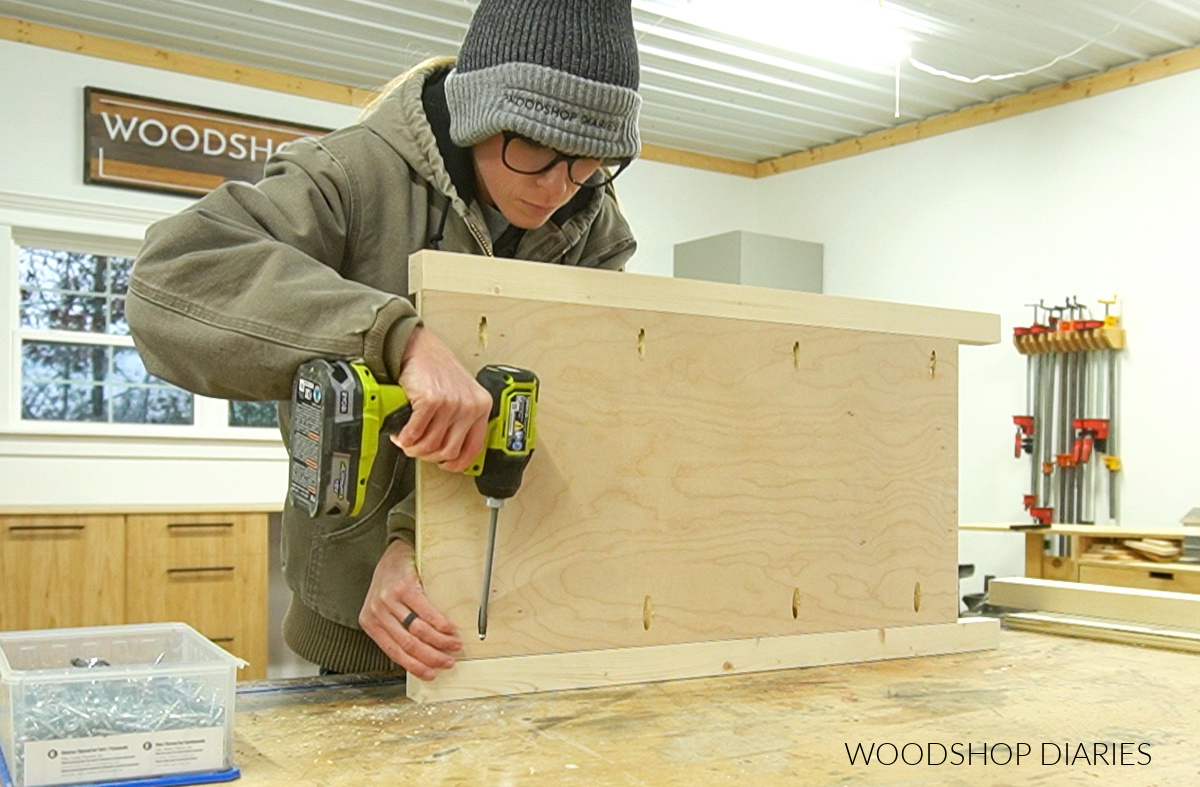 Shara Woodshop Diaries assembling DIY oversized nightstand side panel on workbench using pocket holes