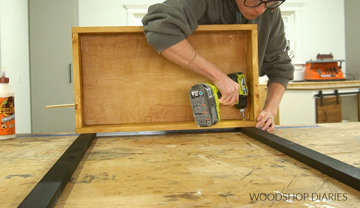 Shara Woodshop Diaries installing bottom shelf/tray to legs/frame to create rolling storage cart
