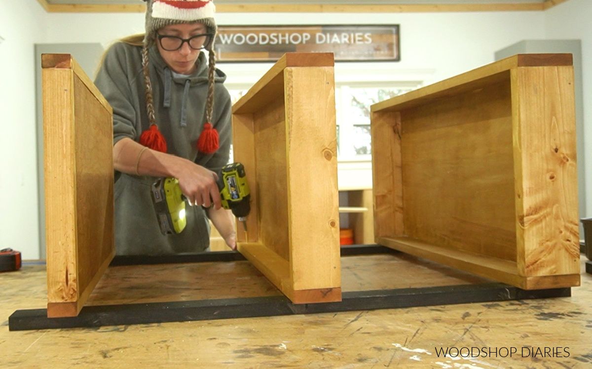Shara Woodshop Diaries screwing middle shelf to cart frame