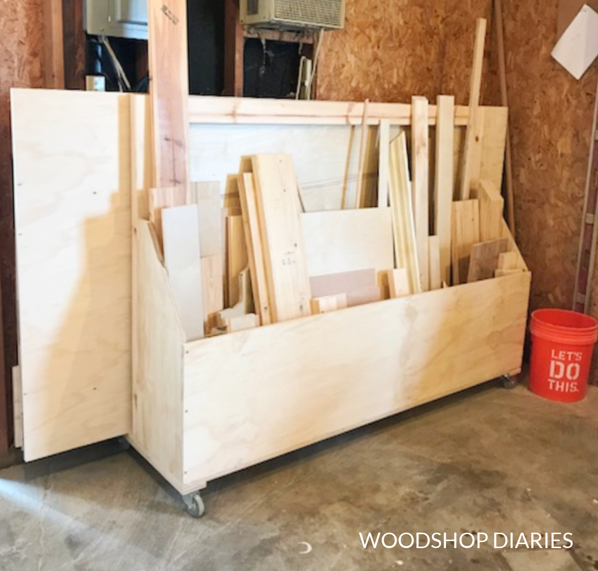 DIY mobile plywood and scrap wood storage cart loaded up with lumber in workshop