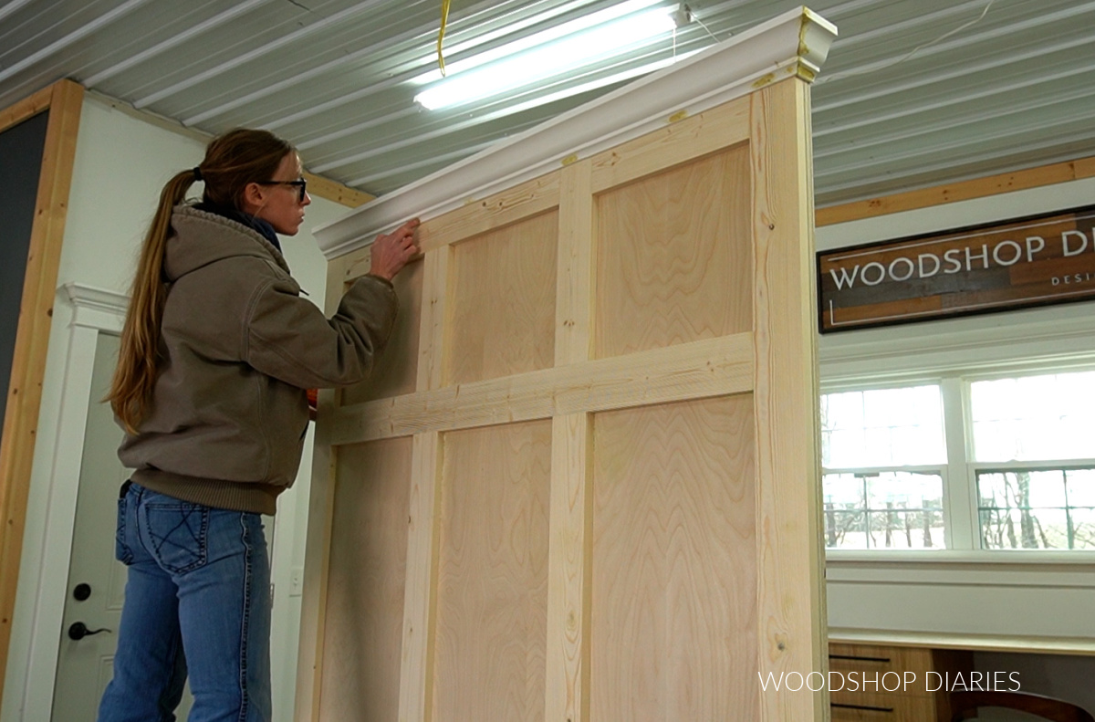 Shara Woodshop Diaries applying wood filler to nail holes on crown molding