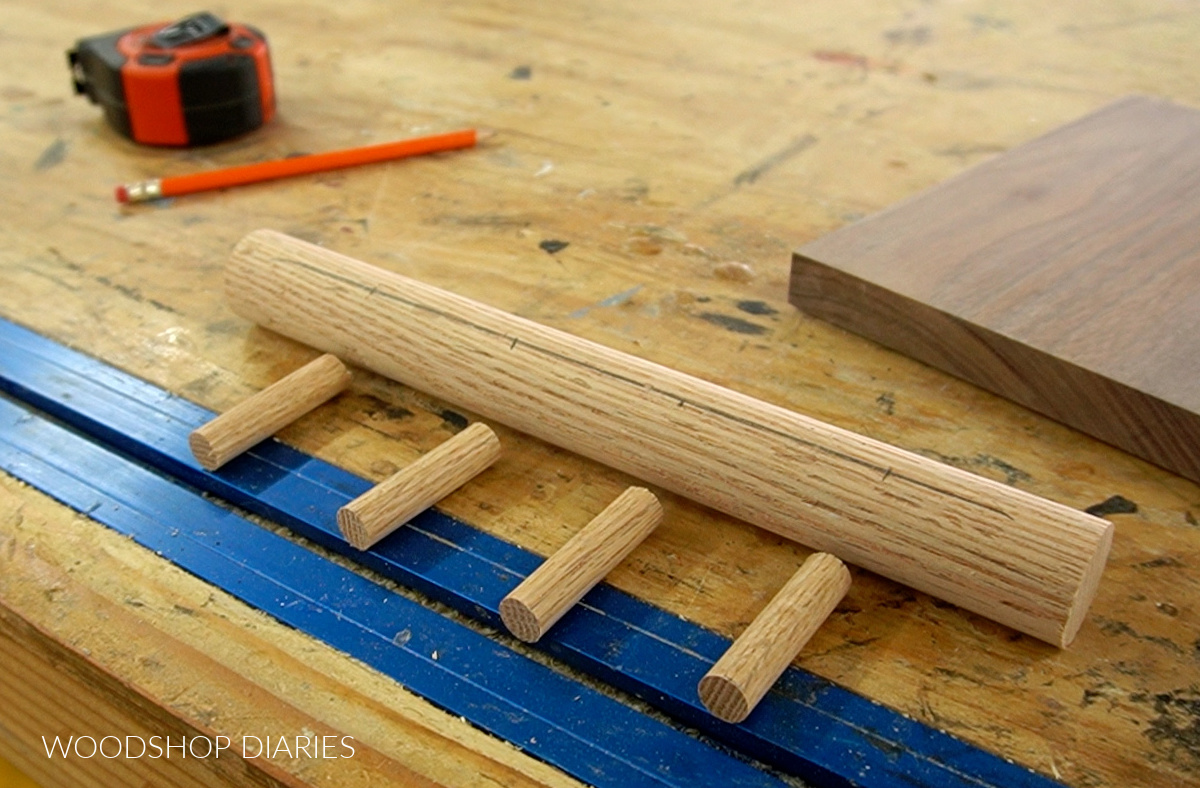 oak dowels and pegs cut to length and laid out on workbench