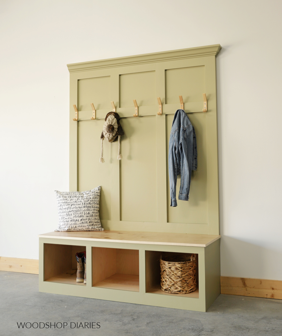 Completed three section hall tree with storage bench painted green with wood seat and wooden coat hooks