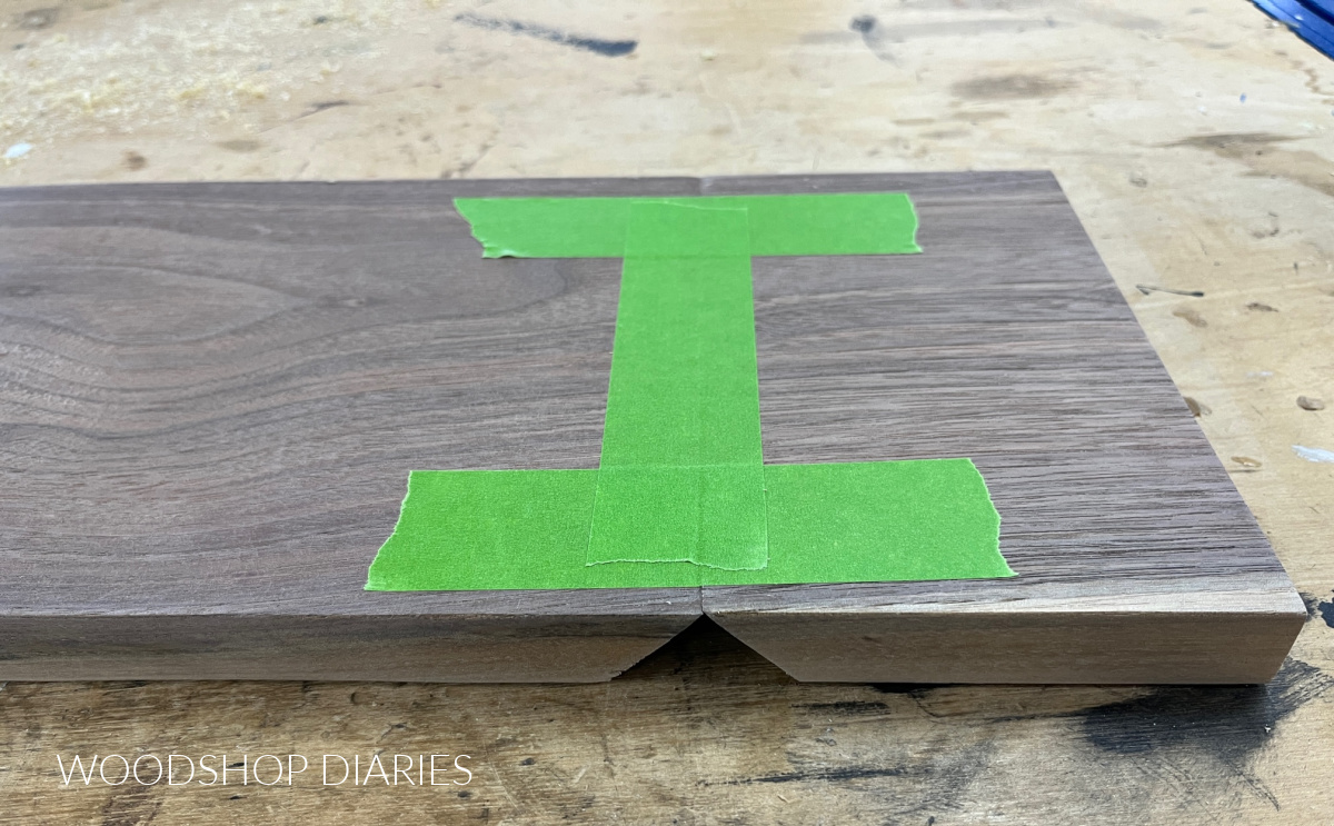 frogtape painters tape placed along mitered edges of walnut boards