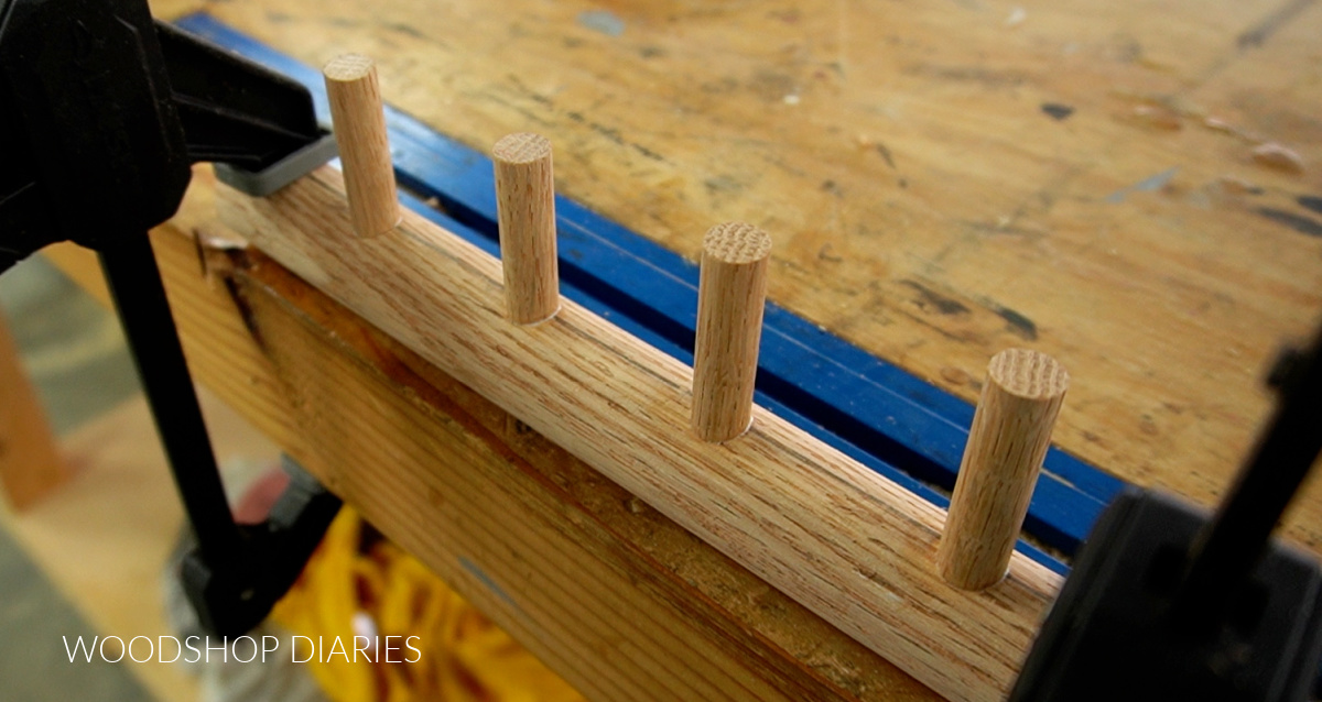 wooden dowel pegs glued into holes drilled on rod