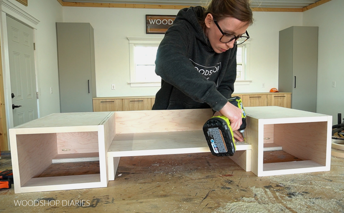 Shara Woodshop Diaries installing center bottom panel into desk