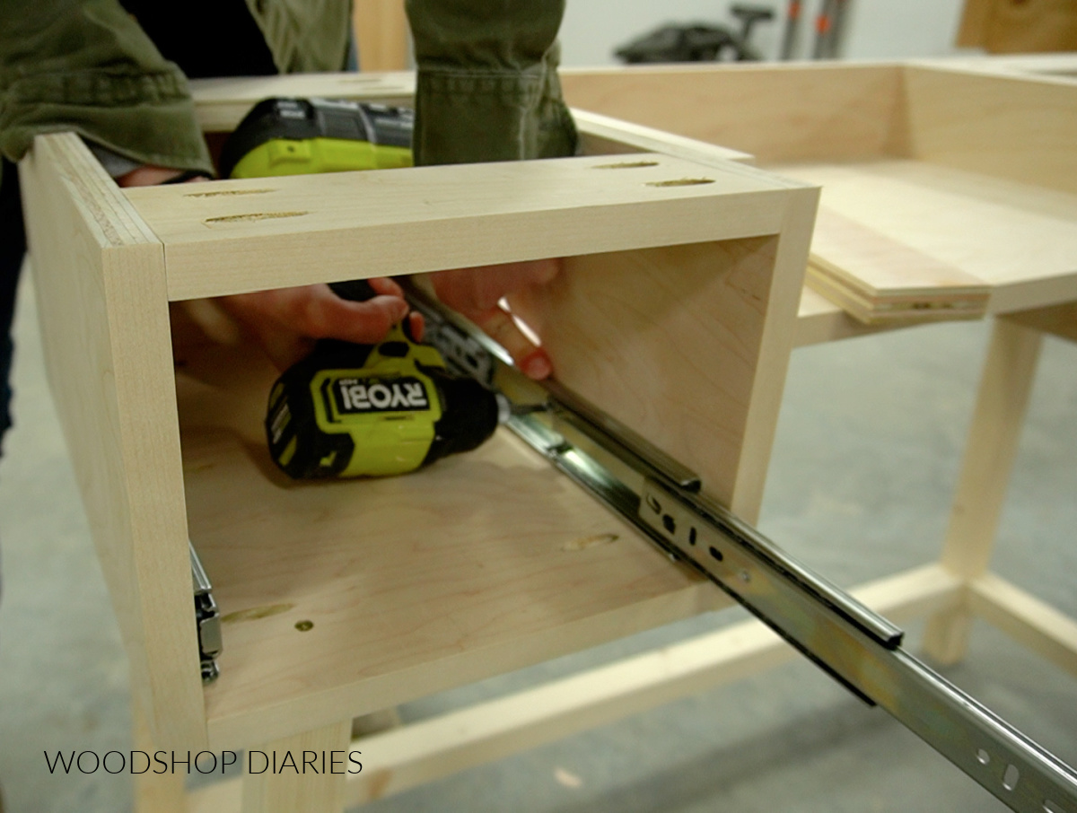 Close up installing drawer slides into desk