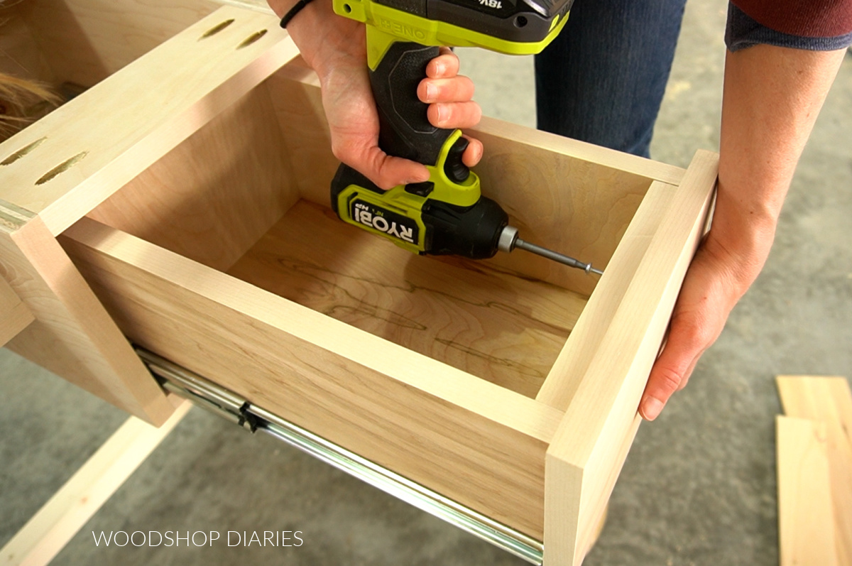 Ryobi driver driving a screw to secure drawer front from inside the drawer box