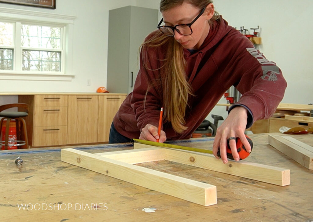 Shara Woodshop Diaries marking dowel locations on sides of desk base