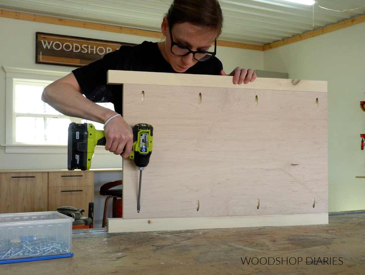 Shara Woodshop Diaries driving pocket hole screws to assemble side panels of end table