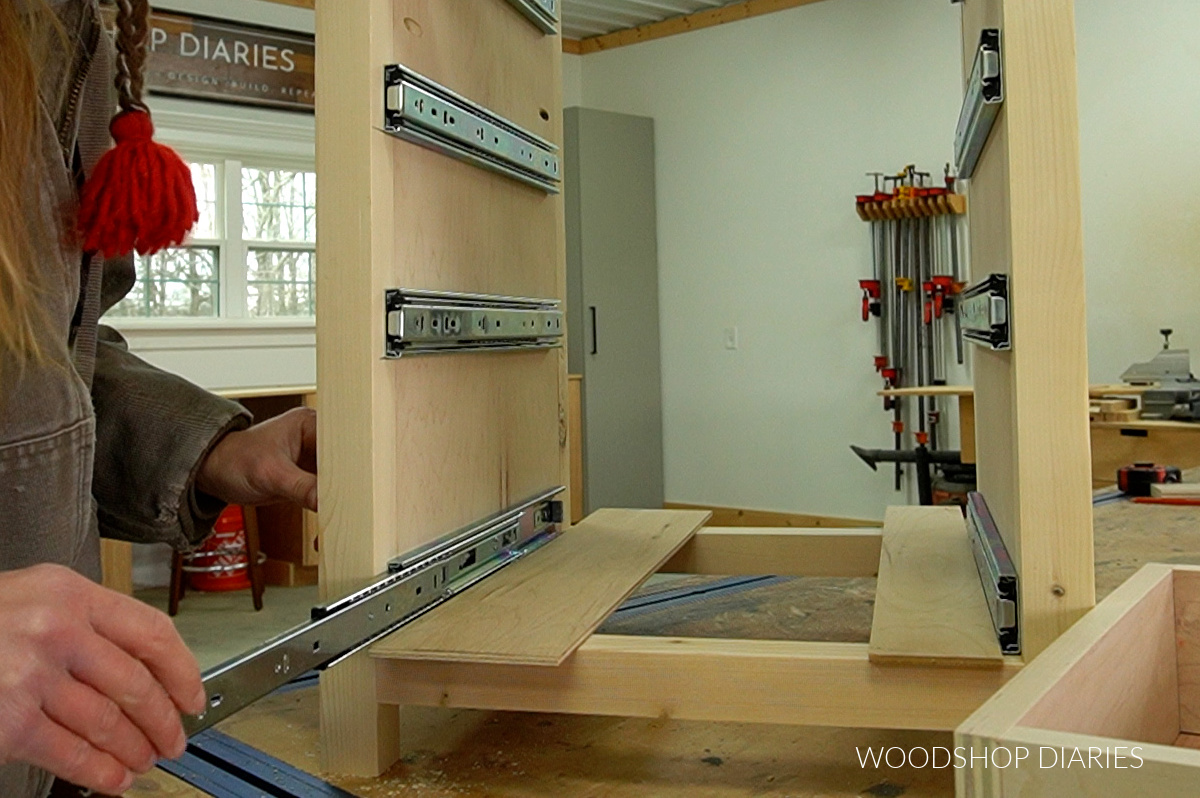 Extending drawer slides in cabinet to prepare for installing drawer boxes