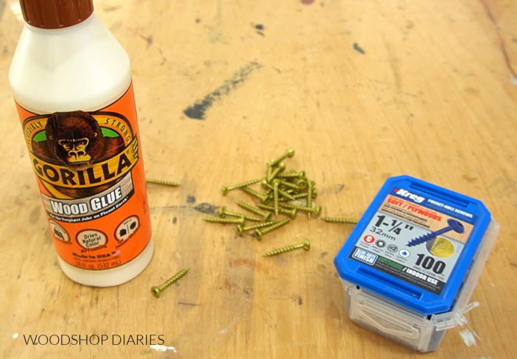 Gorilla wood glue and exterior screws laid out on workbench