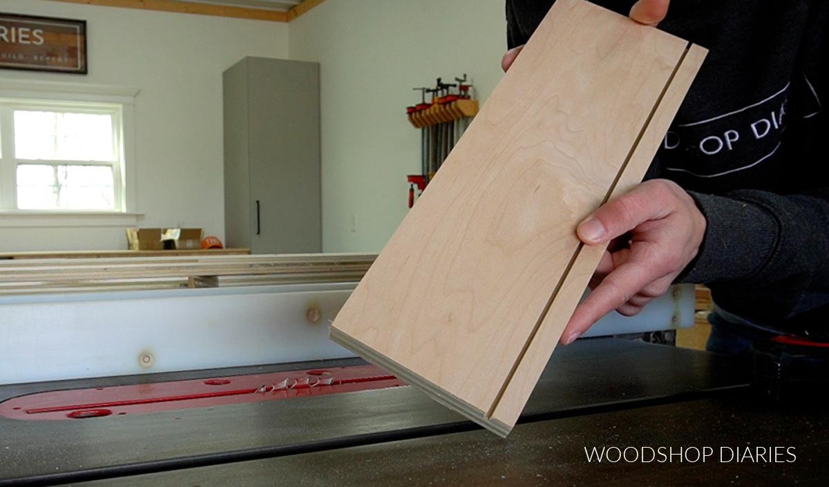 Close up of plywood drawer box side with partially cut dado