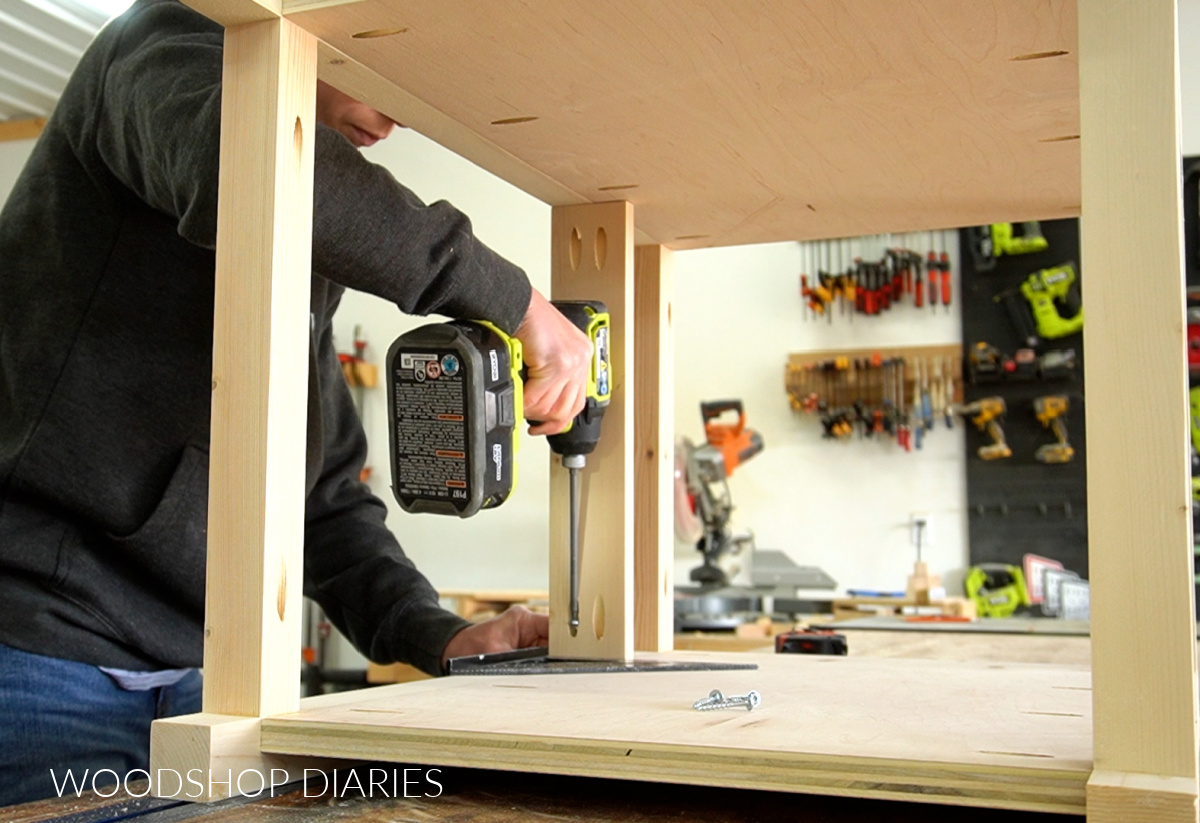 Shara Woodshop Diaries driving pocket hole screws to add drawer divider into end table frame