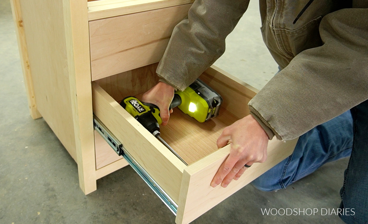 Using a driver to secure drawer fronts from inside of drawer box