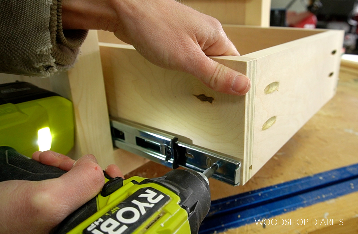 Close up of installing front screw in slide to install drawer box