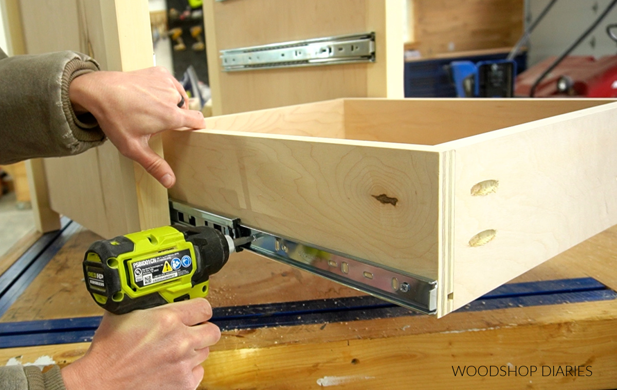 Close up of driving middle screw in slide to install drawer box