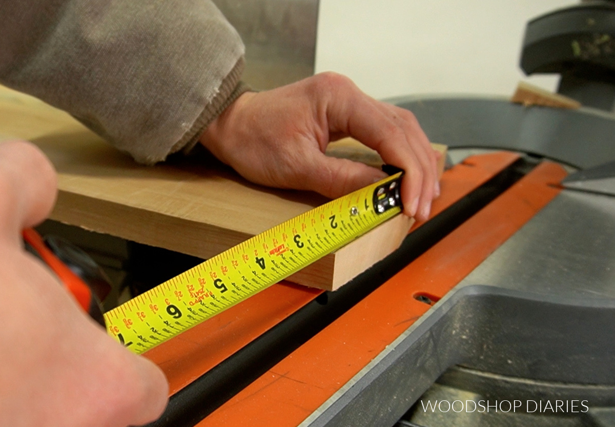 close of of measuring 15 degree miter edge on corner of board on miter saw