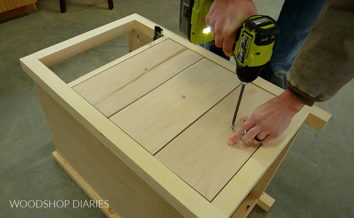 Driving screws through center of drawer front to temporarily secure drawer fronts