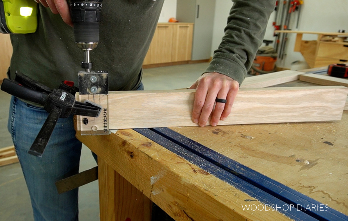Shara Woodshop Diaries drilling dowel holes in board with clamp on dowel jig
