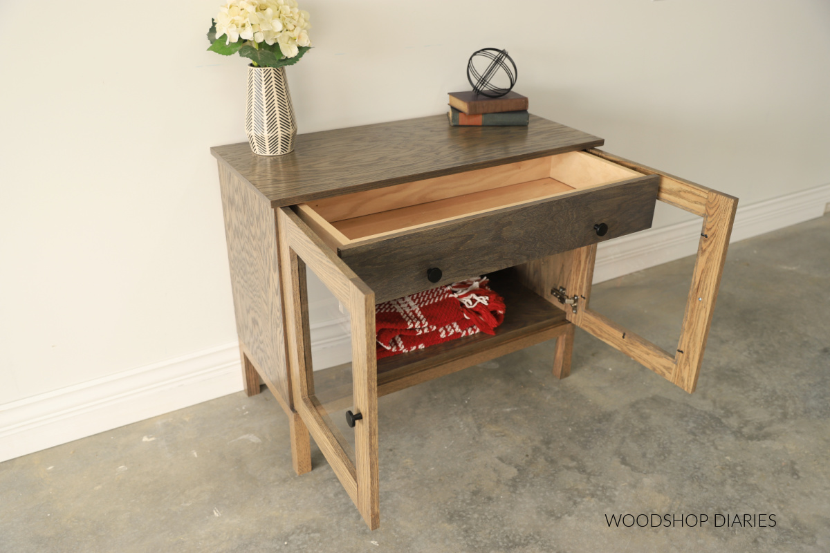 Red oak DIY display cabinet with doors open and drawer extended 