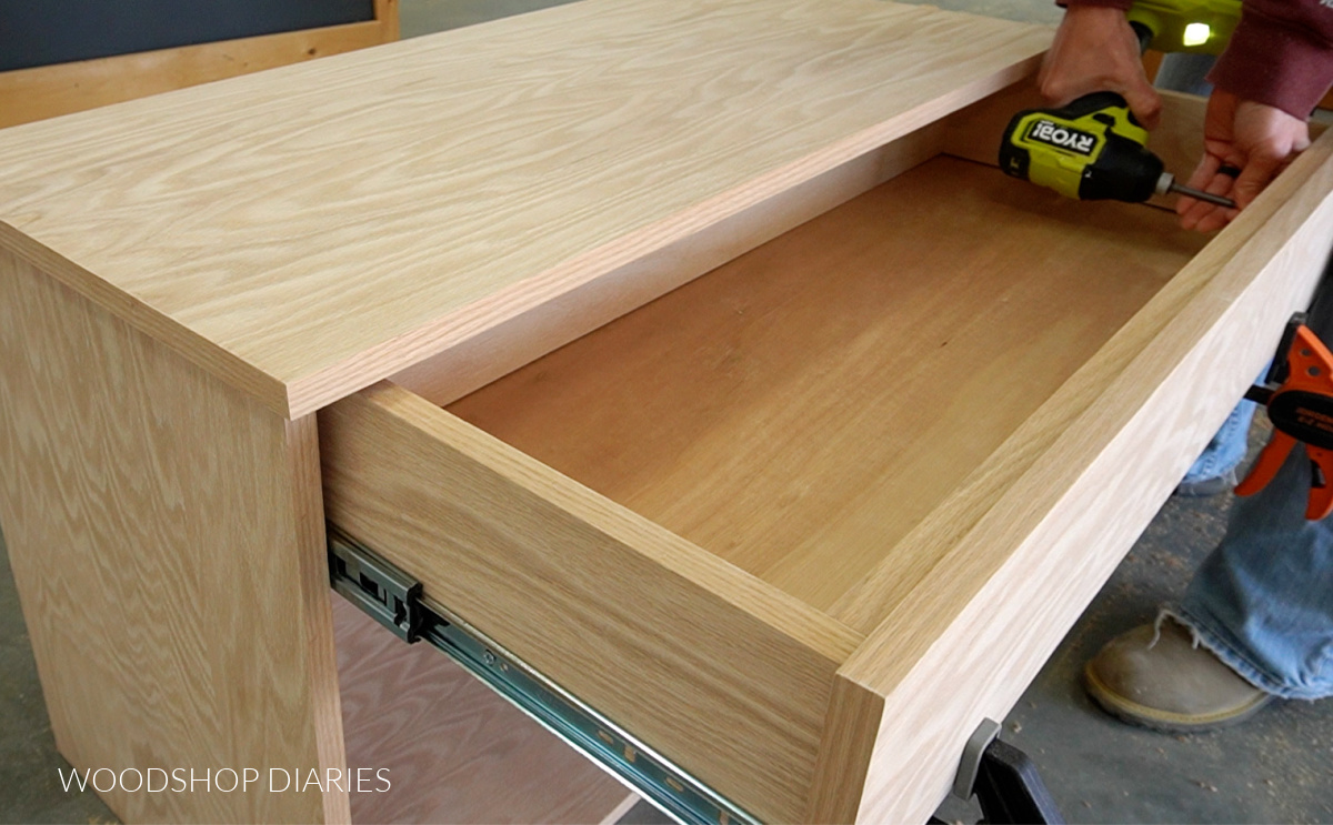 Using screws from inside drawer box to secure drawer front on console cabinet 