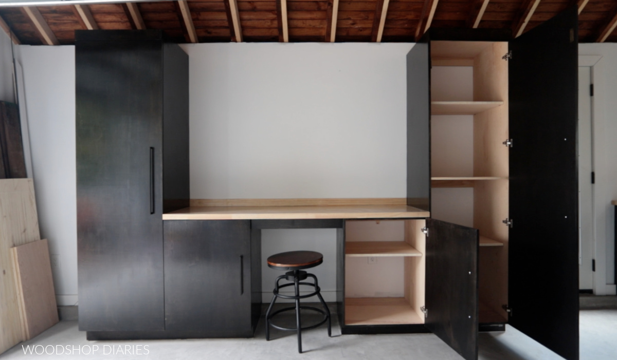 Garage cabinets in workshop with doors open to reveal adjustable shelves