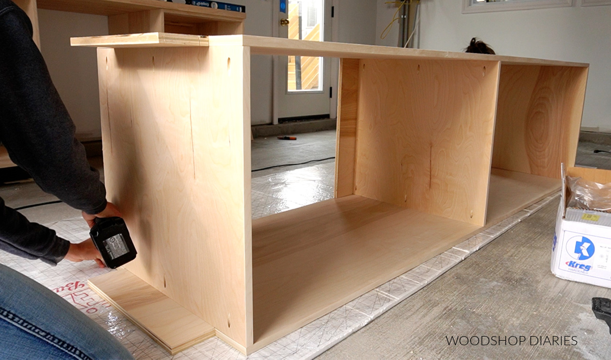 Assembling tall garage storage cabinet using pocket holes on workshop floor