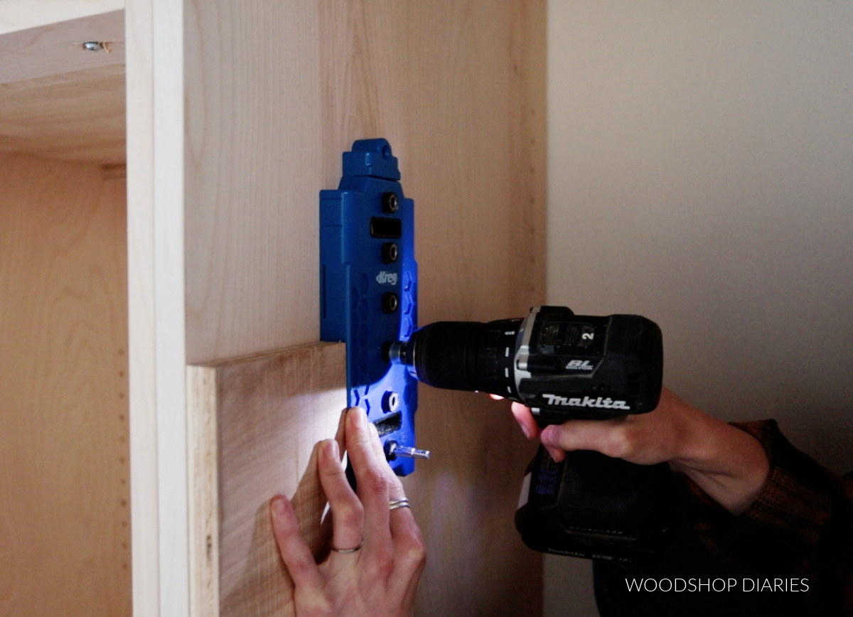 Drilling shelf pin holes inside cabinet with scrap block on front edge