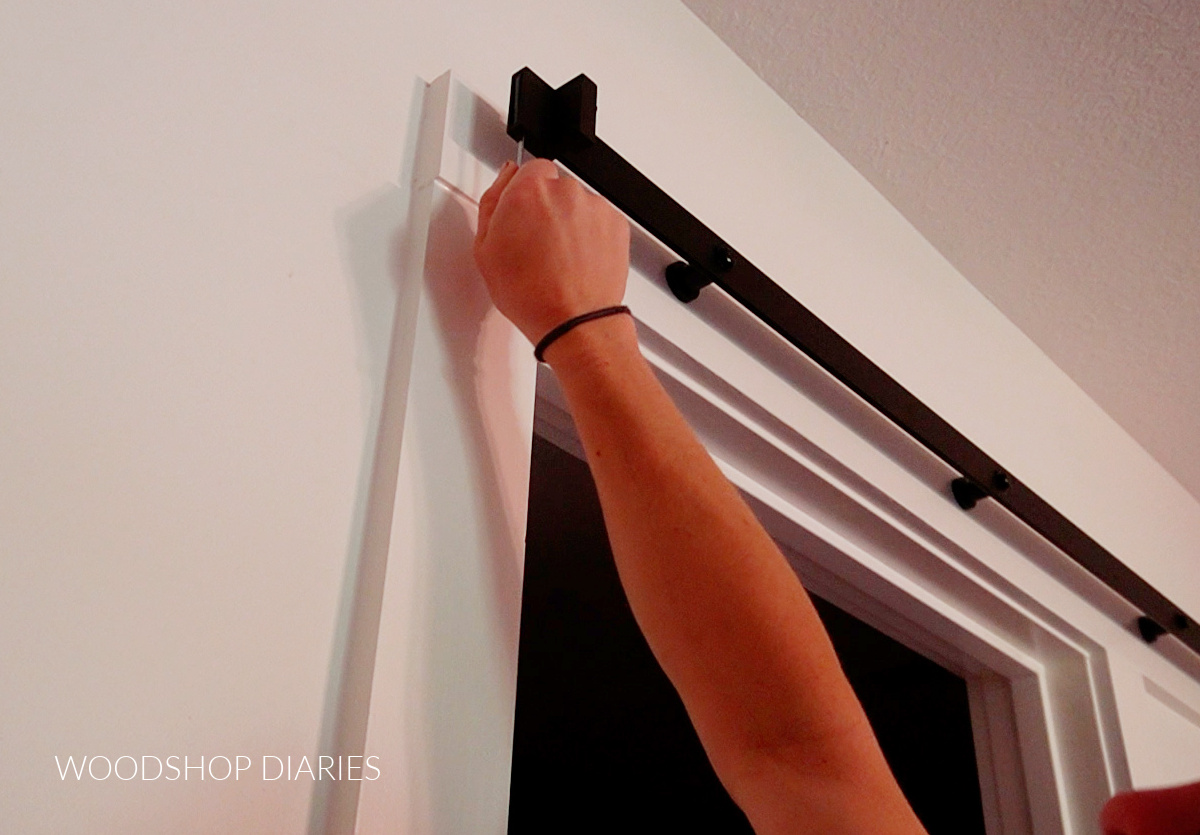 Tightening end stoppers on sliding door rail 