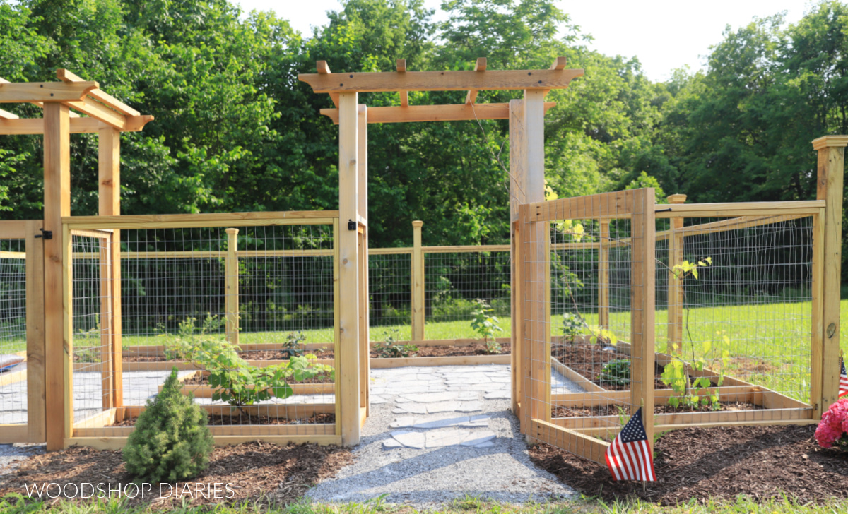 Fenced garden with arbor used as entrance with gate open