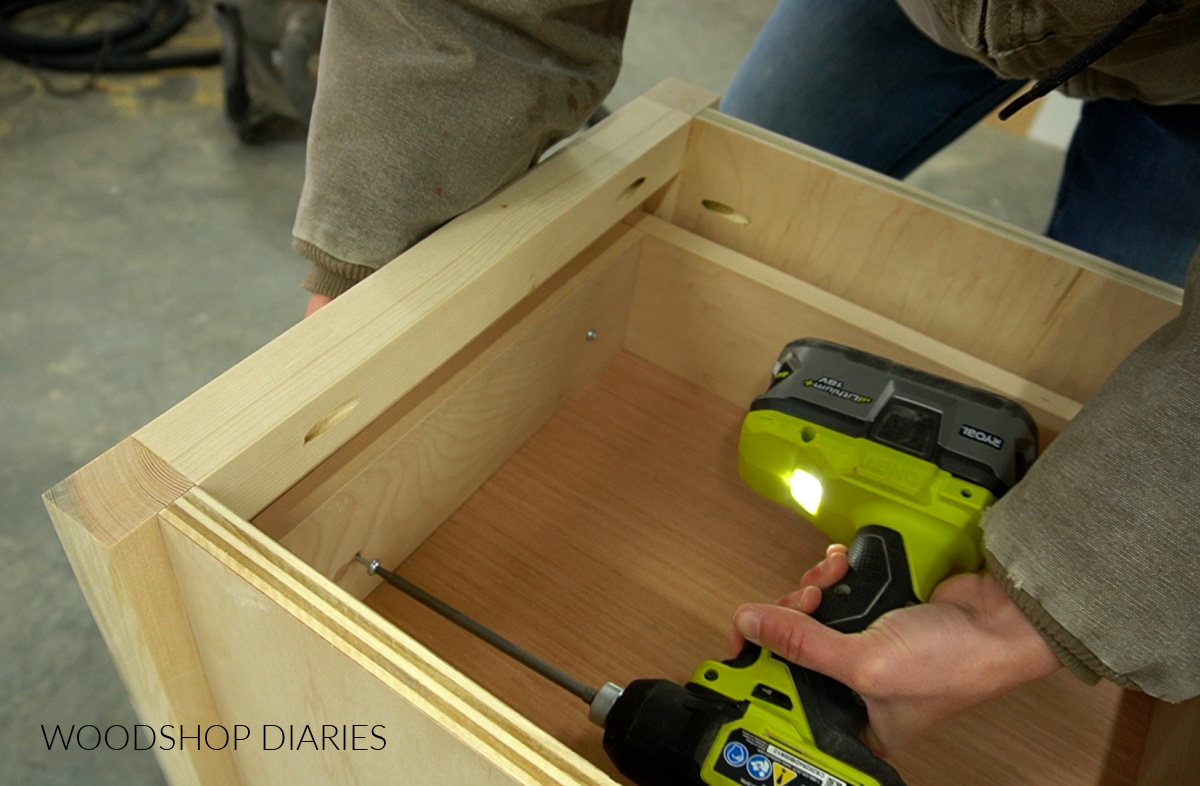 Using a driver to install drawer front with screw through front of drawer box on end table project