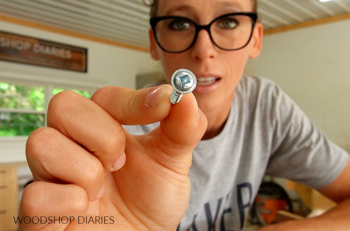 Close up of Shara Woodshop Diaries holding a pocket hole screw with washer head