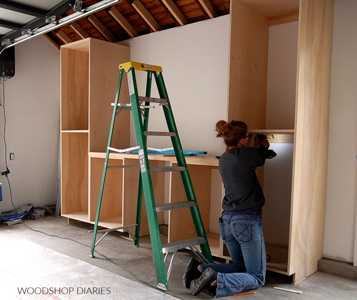 Shara Woodshop Diaries installing plywood cabinets onto garage wall