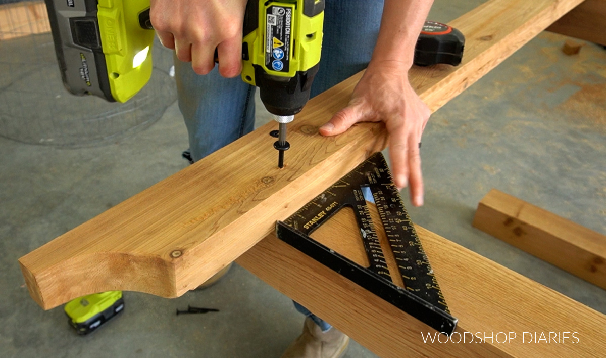 Using black accent timber screws to secure top frame support between sides of garden arbor build