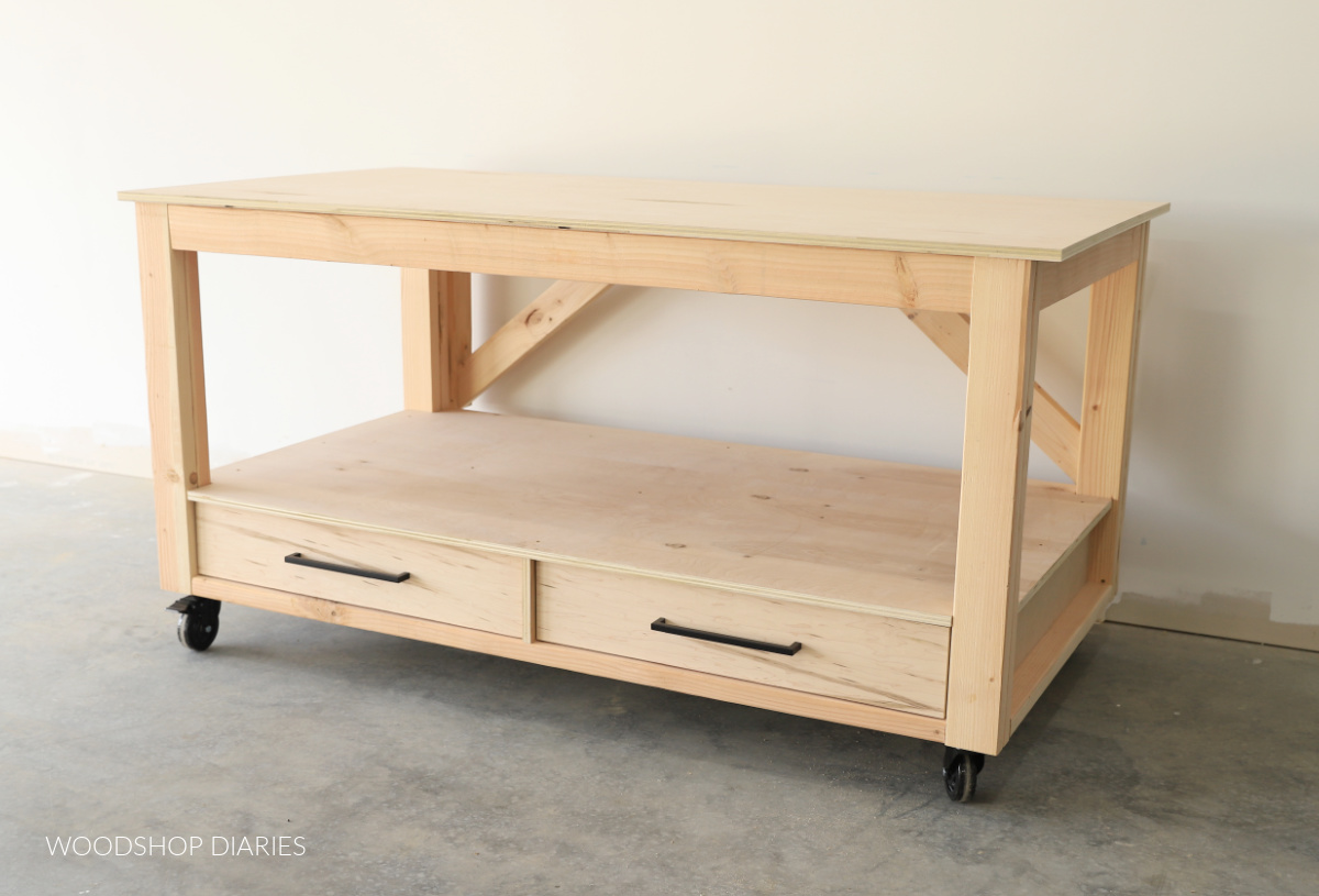 DIY mobile workbench with drawers at bottom and open middle shelf made from 2x4s and plywood