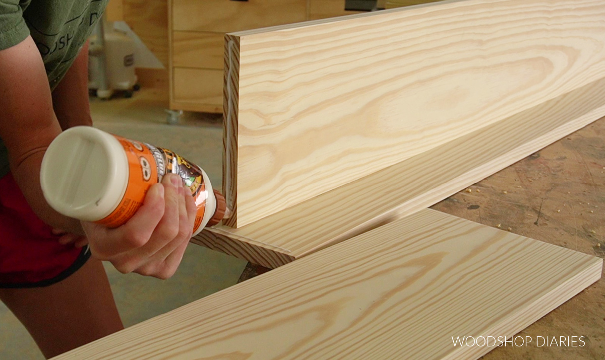 Applying wood glue to bottom of shelf