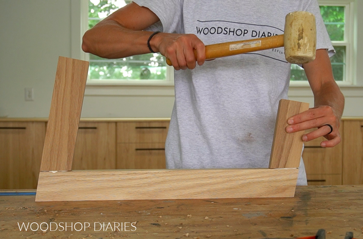 Shara Woodshop Diaries using rubber mallet to assemble table base with wood glue and dowels