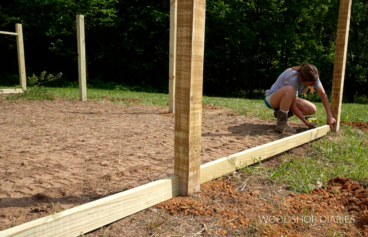 Shara Woodshop Diaries installing bottom fence framing 2x4 between 4x4 posts for enclosed walk in garden