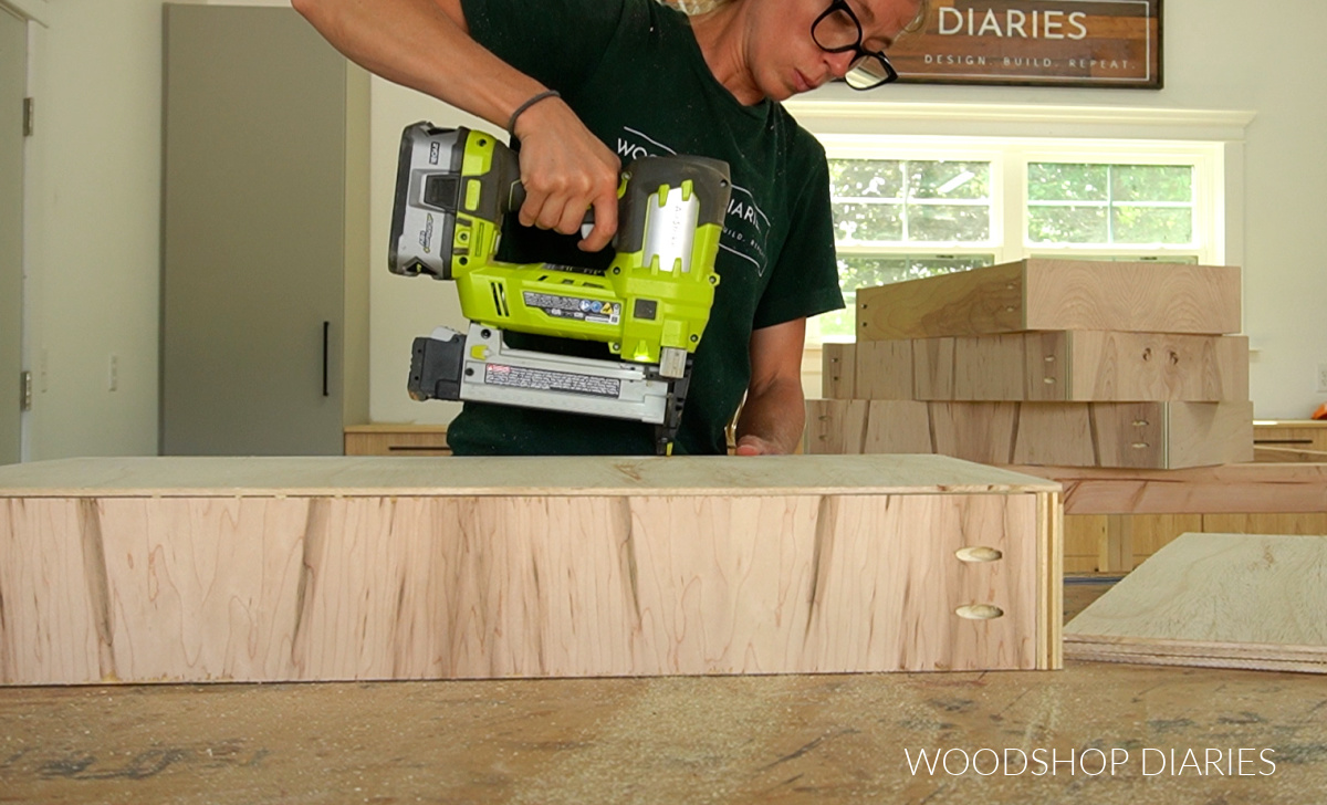 Shara Woodshop Diaries stapling drawer bottom panels onto drawer box