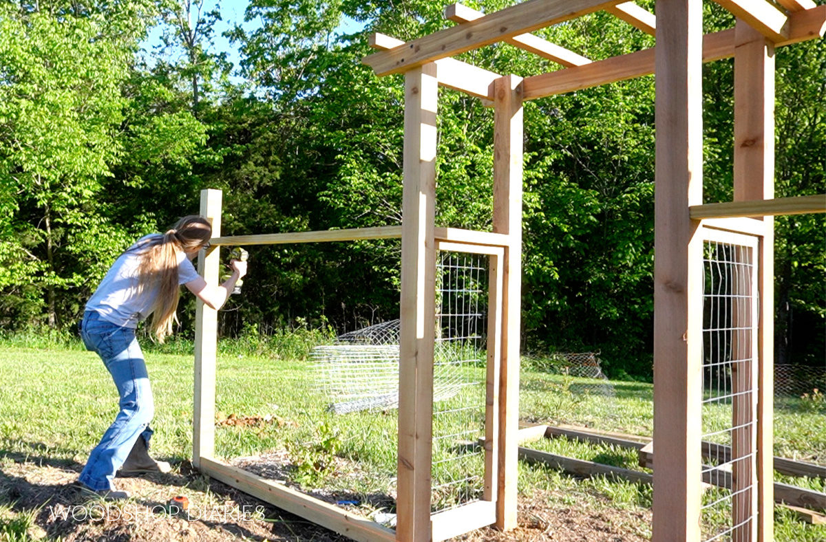 Shara Woodshop Diaries installing fencing framing between garden arbor and post