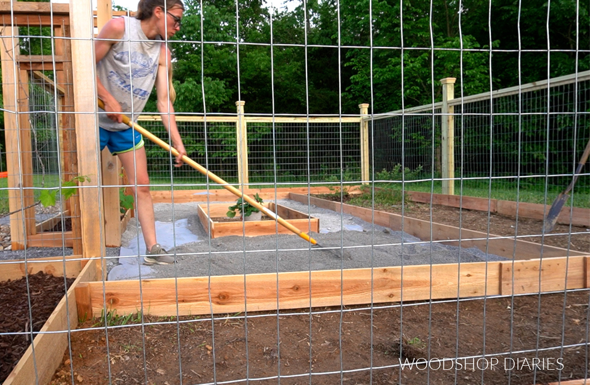 Shara Woodshop Diaries spreading paver base rock inside enclosed garden area