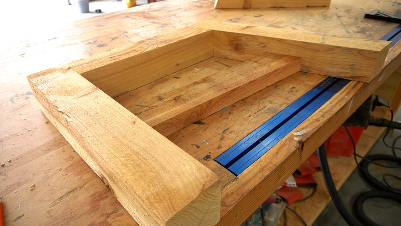 Side frame of loveseat laid out on workbench--cedar 4x4s and 2x4s dry fit together