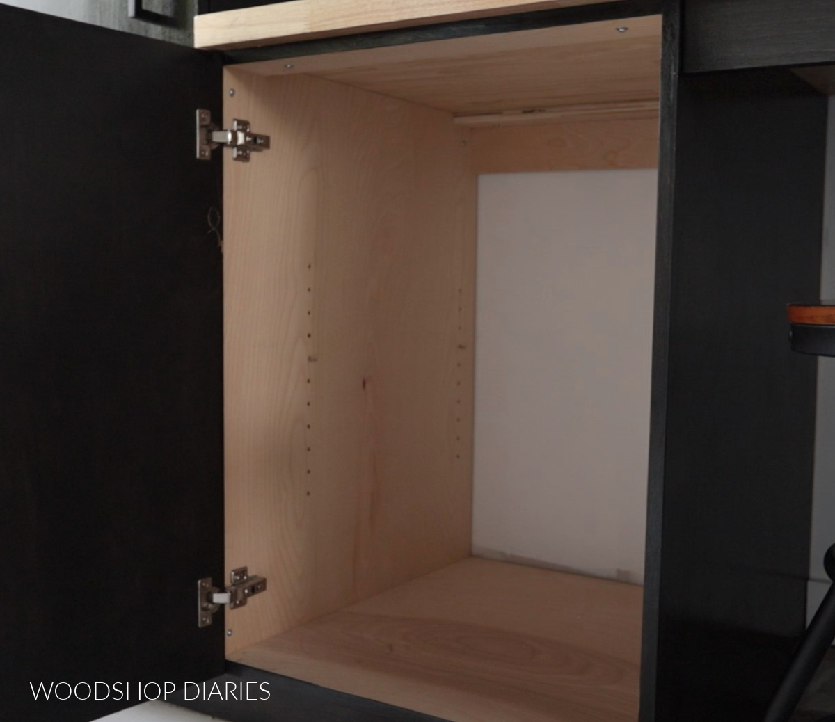 Looking at shelf pin holes drilled inside cabinet