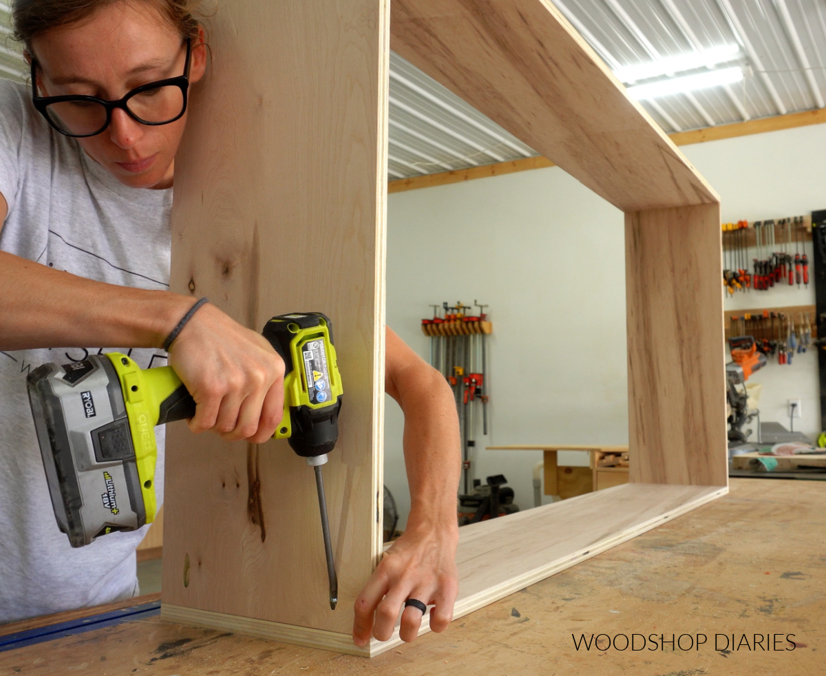 Shara Woodshop Diaries assembling bookshelf body on workbench using pocket holes and screws