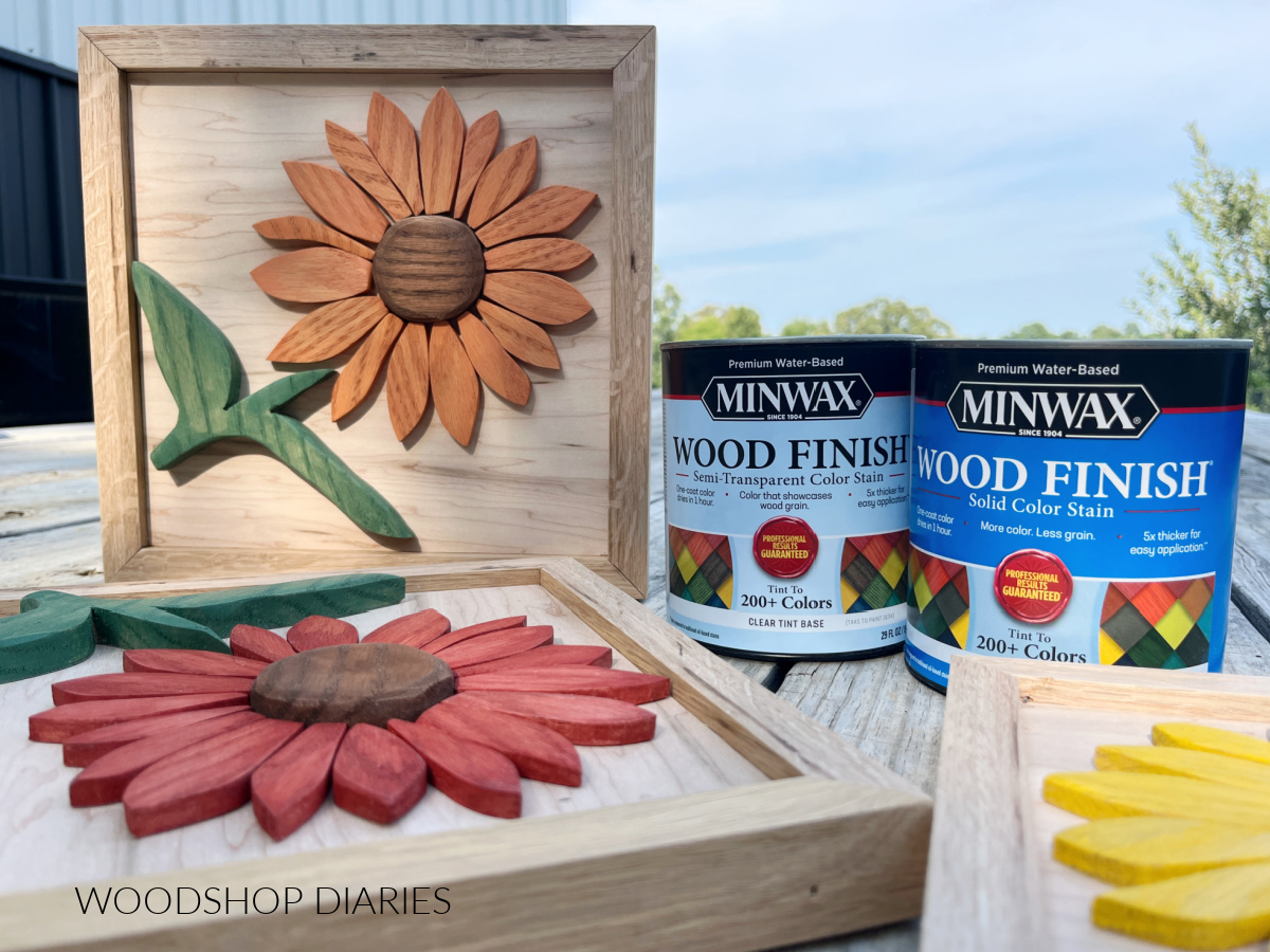 Completed wooden sunflowers displayed next to minwax stain cans