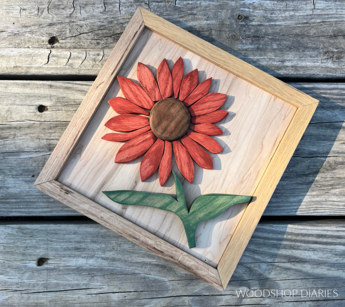 Close up of wood sunflower art with red stained wooden petals made from scrap wood