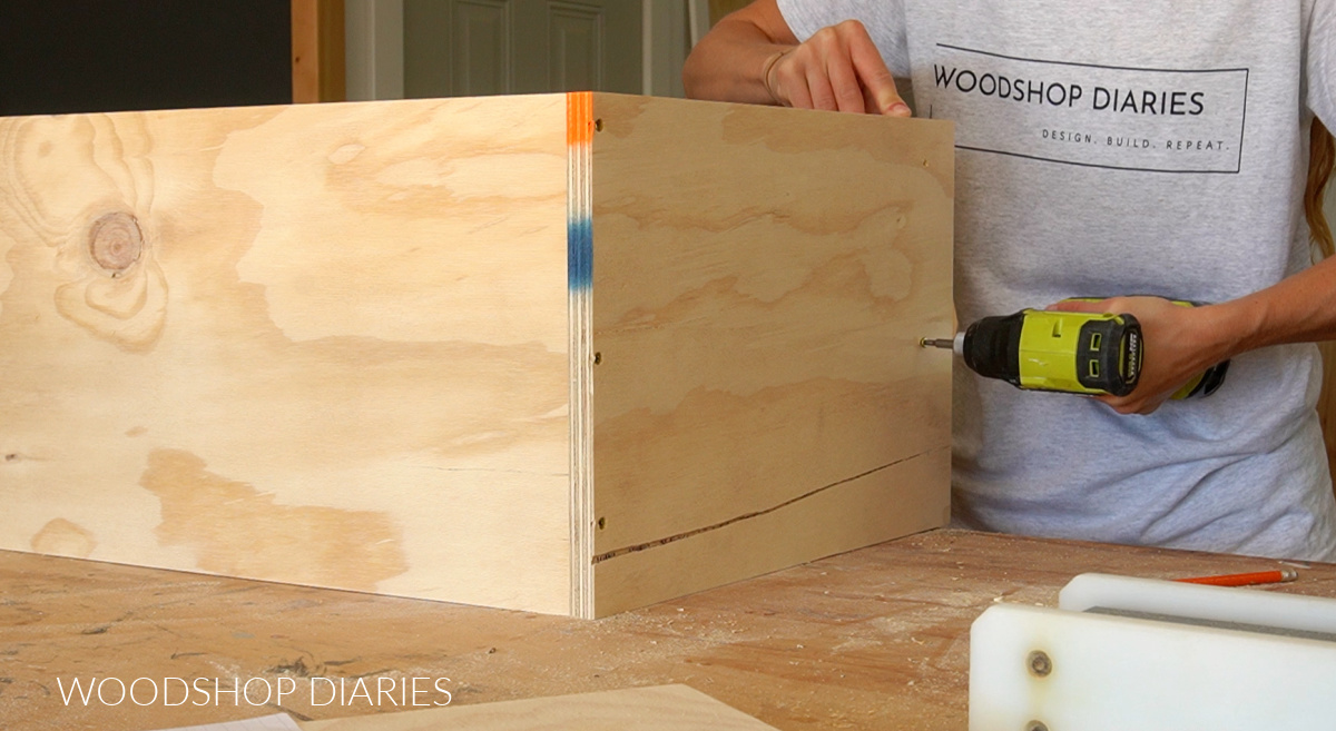 Shara Woodshop Diaries driving screws to assemble plywood cabinet