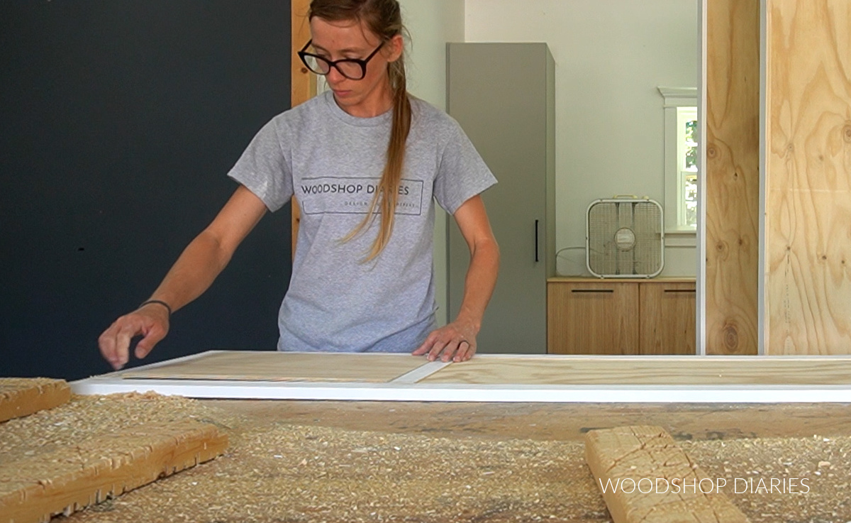 Shara Woodshop Diaries placing plywood panels into door frame