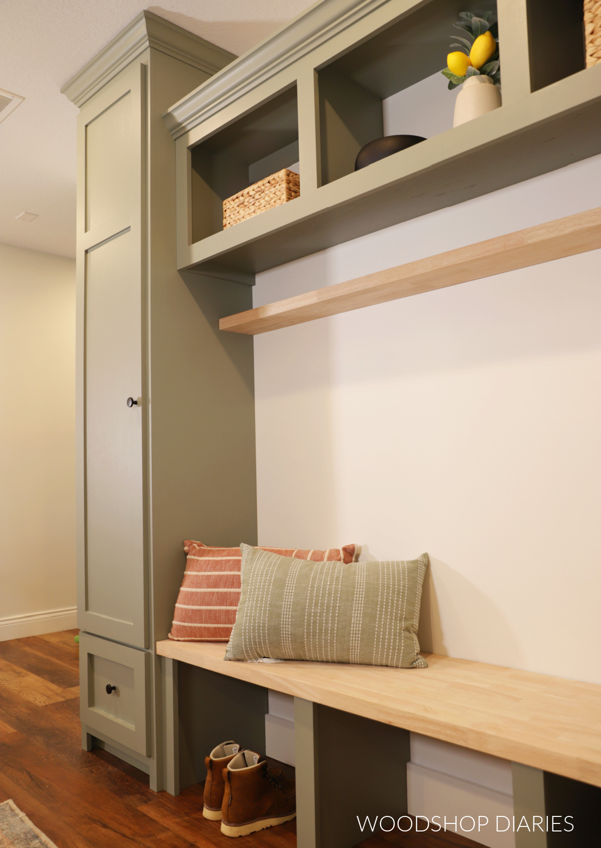DIY mudroom cabinets in hallway with open bench seat and tall storage cabinet